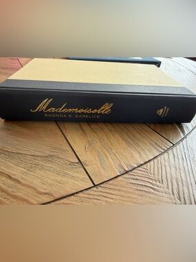 Mademoiselle by Rhonda K. Garelick Hardcover Book in Black and Tan